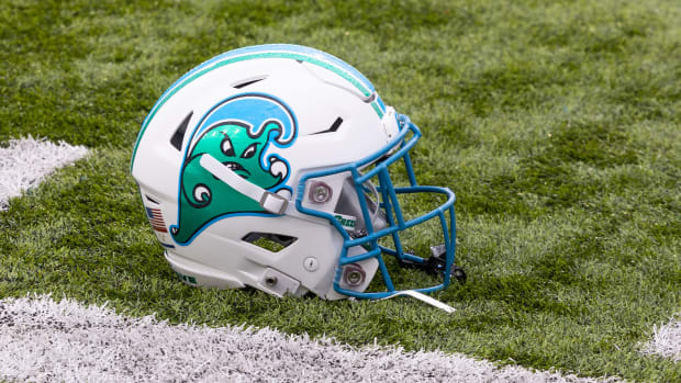 A tulane football helmet sits on the turf